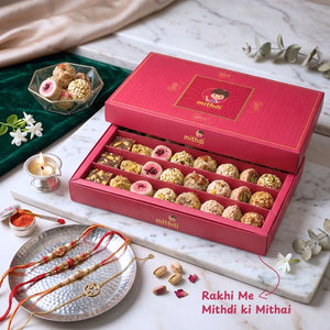 Mithdi assorted sweet box for Rakhi celebration featuring traditional rakhis and festive items