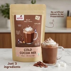 Mithdi Sweets Surat Cold Cocoa Mix packaging with glass mug of chocolate drink – premium Indian sweets brand offering best sweets in Surat and bulk sweets order India