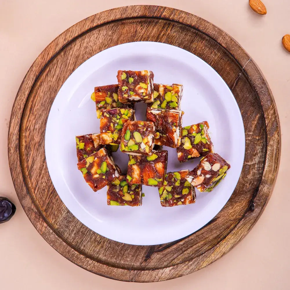 A stack of Khajur chikki made with dates and nuts, a top choice for those looking to buy khajur chikki online for healthy gifting.