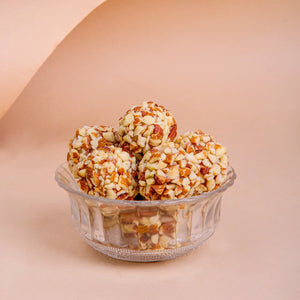 A bowl of Roasted Almond Ladoo, a favorite healthy sugar free sweets option available at Mithdi sweets Surat.