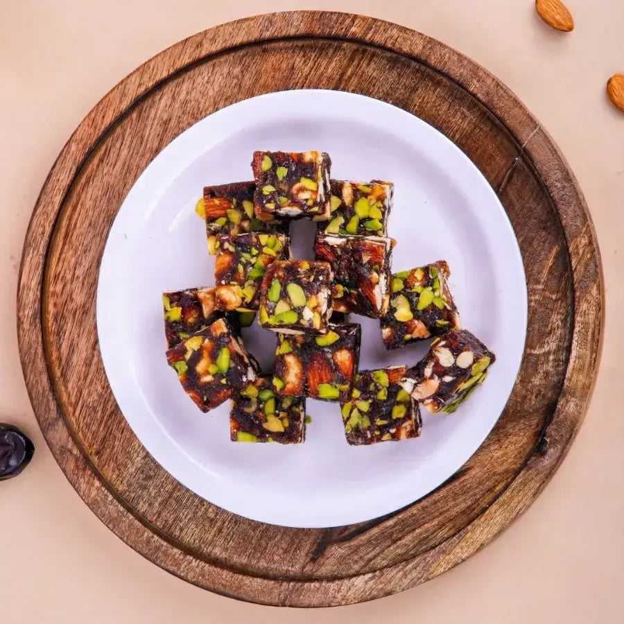 Buy Khajur Chikki online or get Khajur chikki delivery in Surat, India. Featuring the best Khajur dry fruit chikki online from Surat.