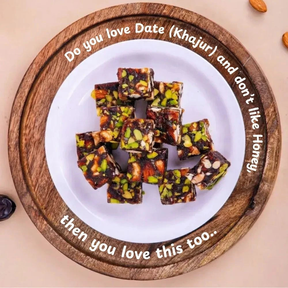 Handcrafted Mithdi Black Date Bites arranged on a wooden serving board.